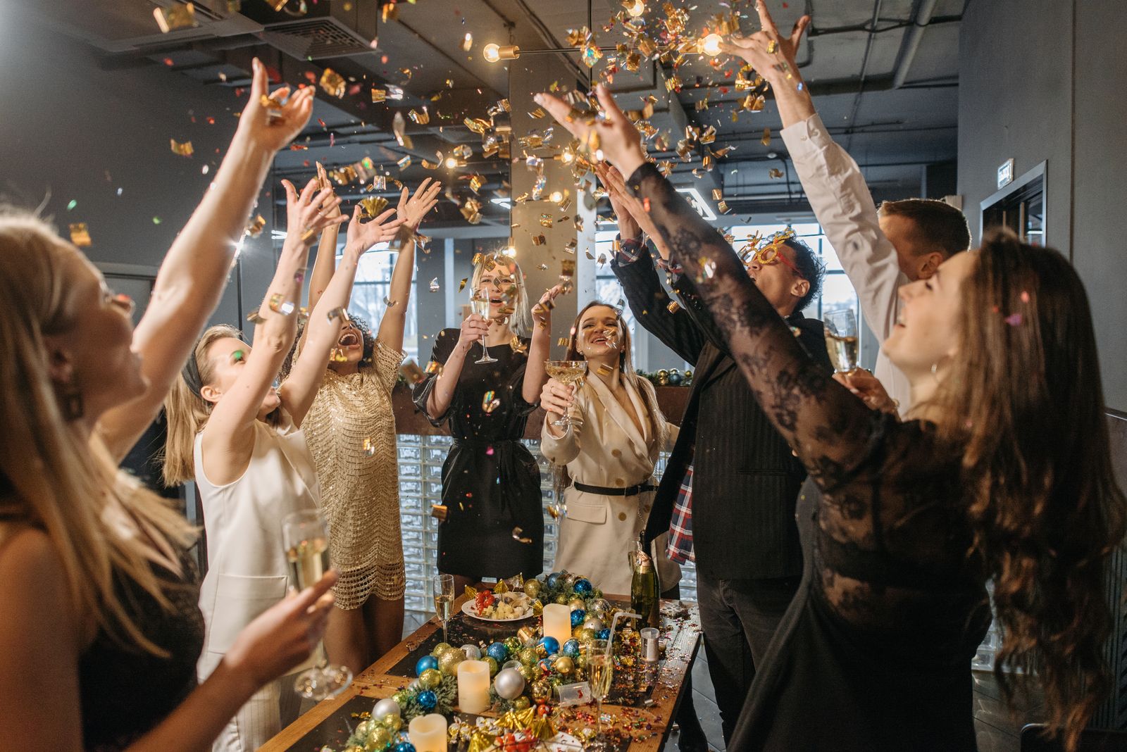 A team celebrating with confetti at a holiday party