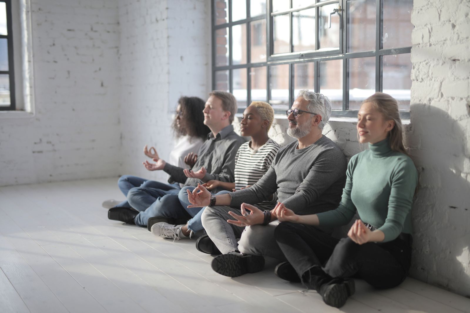 A group in a calm guided session by a bright window